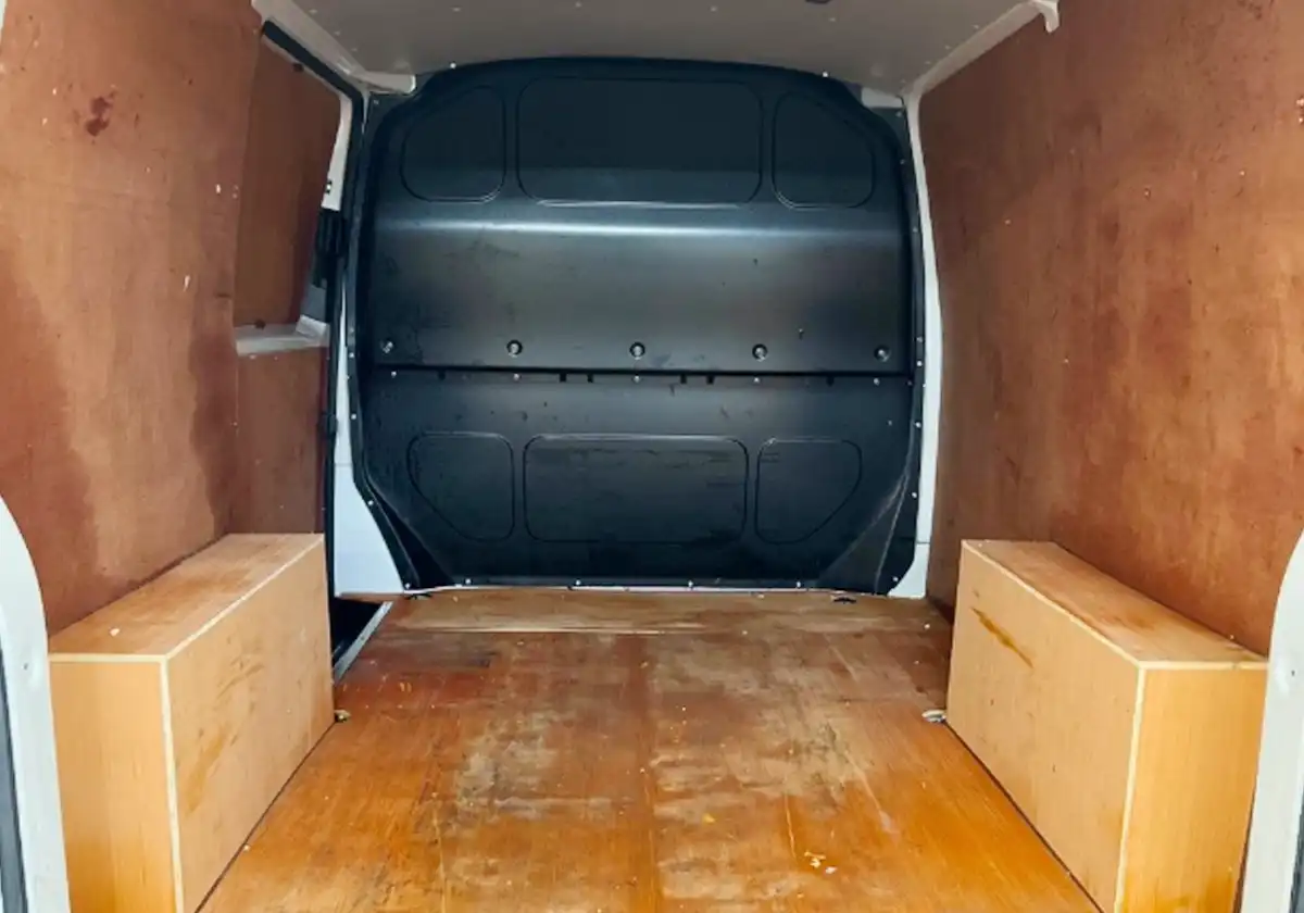 the back of a Volkswagen Transporter with a wooden floor.
