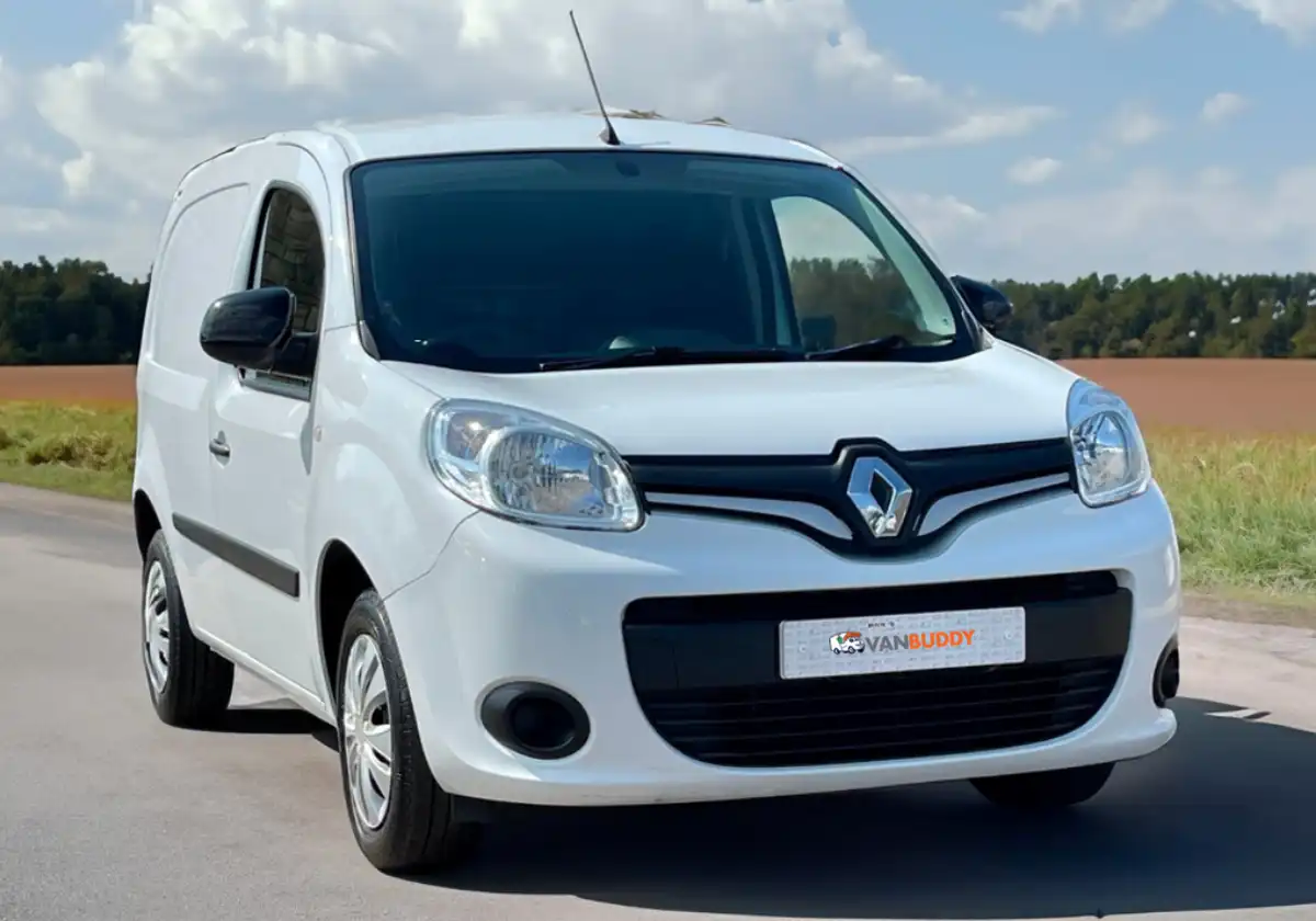 a white Renault Kangoo driving down a country road.