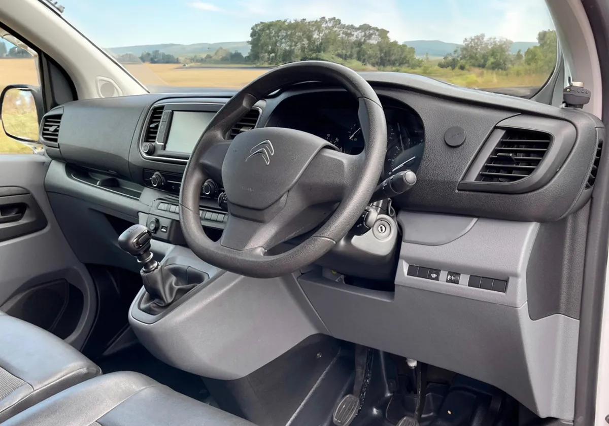 the interior of a Citroen Dispatch with a steering wheel and dashboard.