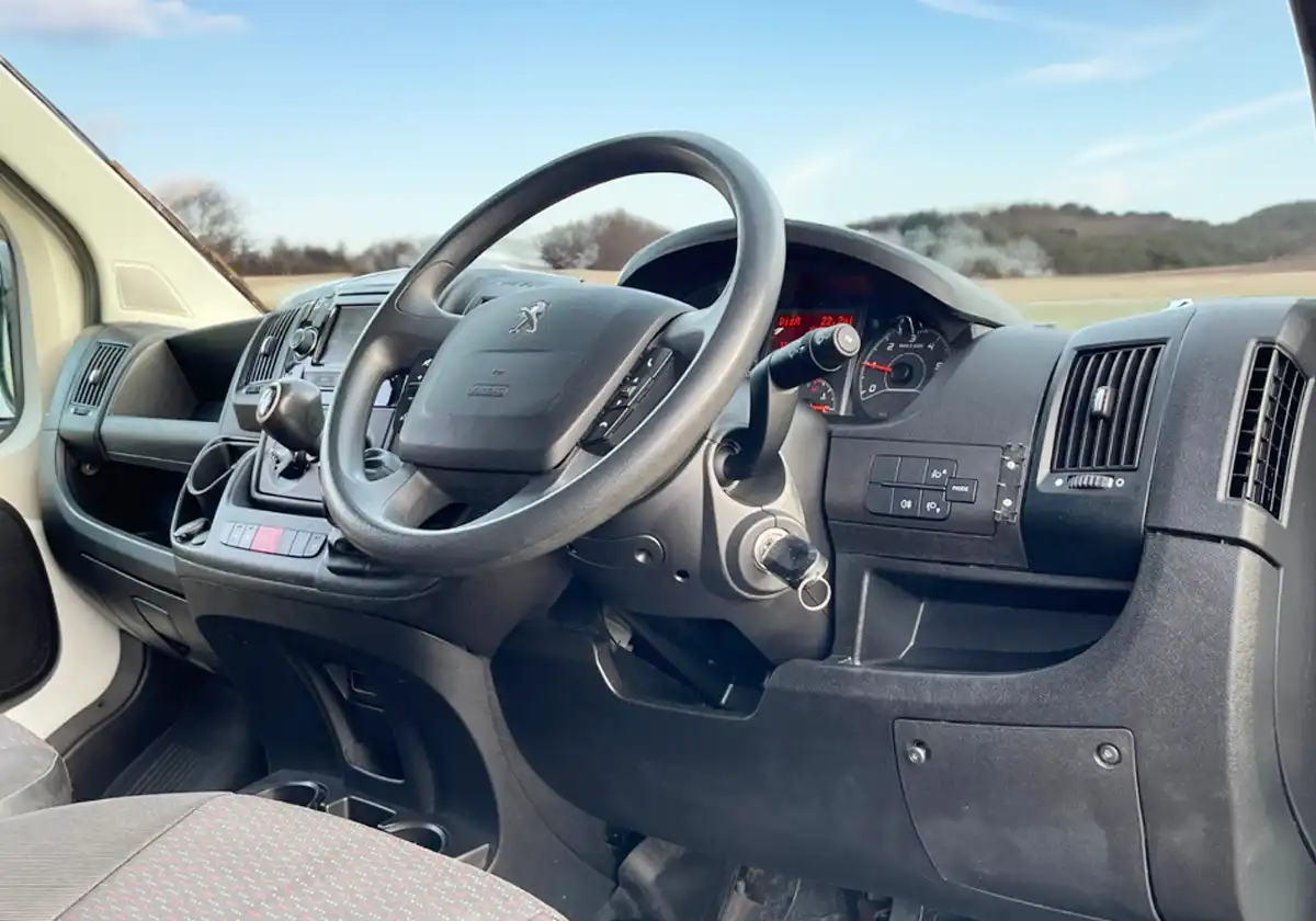 the interior of a Peugeot Boxer with a steering wheel and dashboard.