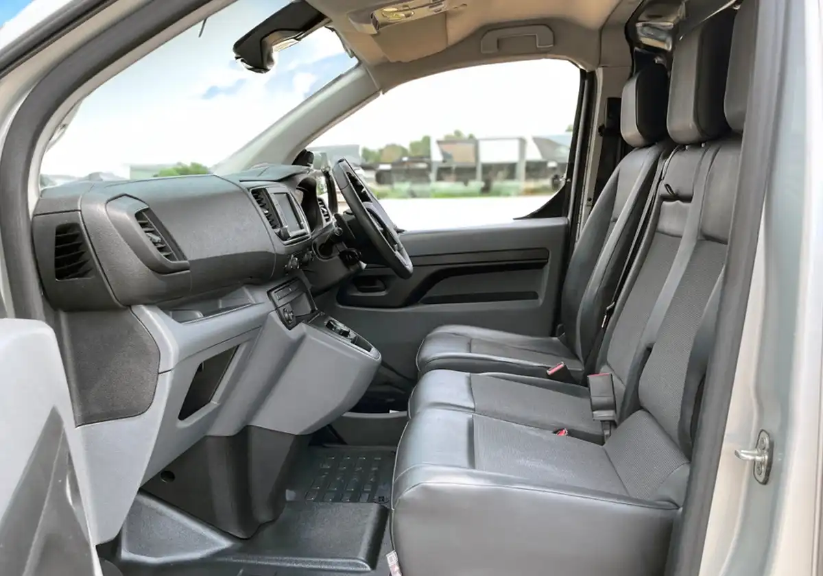 the interior of a grey Peugeot Expert with leather seats.