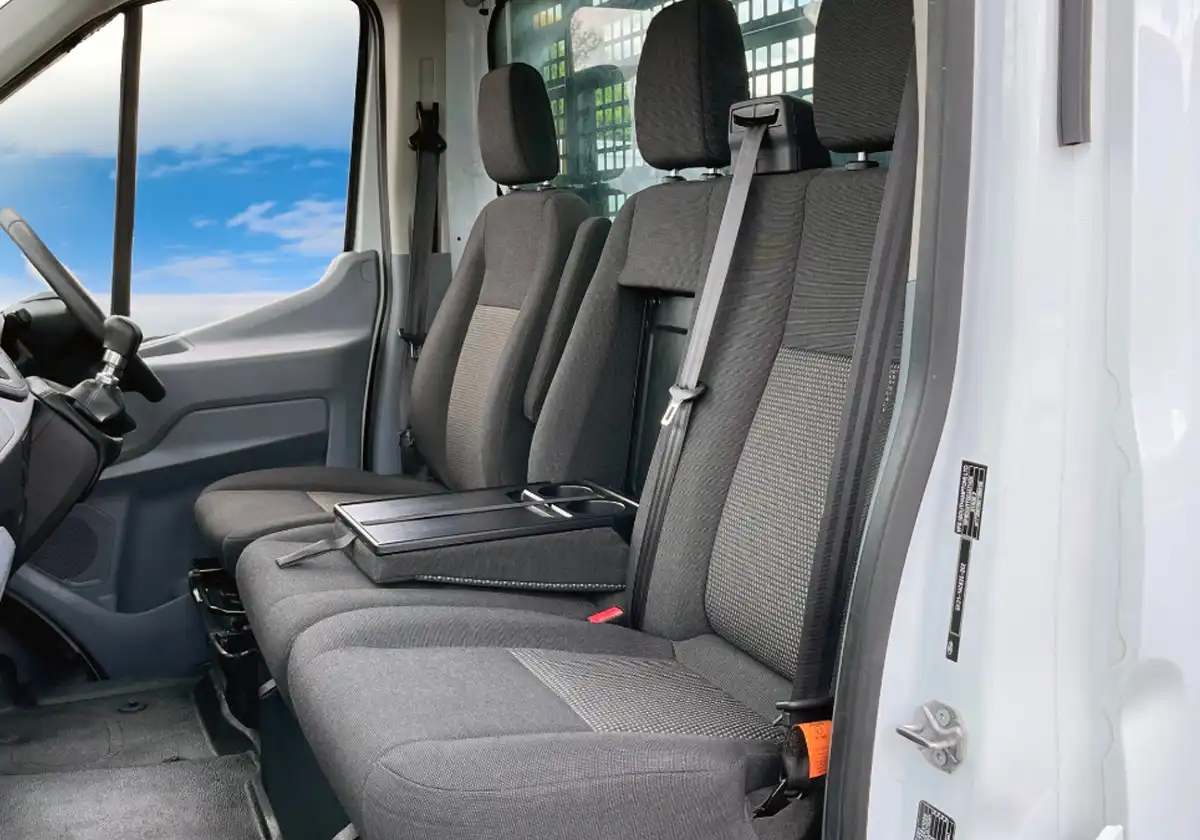the interior of a Ford Transit Dropside with the seats open.