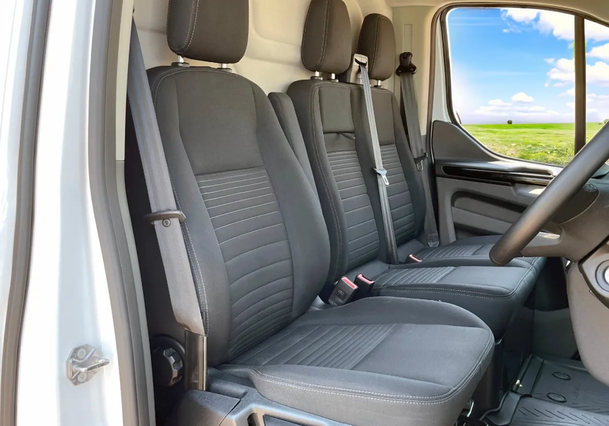 the interior of a Ford Transit Custom with black leather seats.