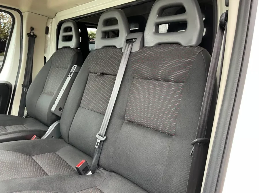 the back seats of a Peugeot Boxer Low Loader with black seats.