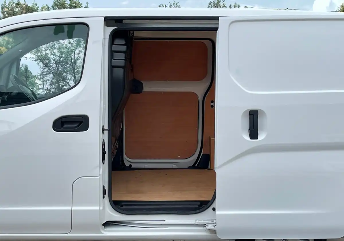 a white Nissan NV200 with the door open.