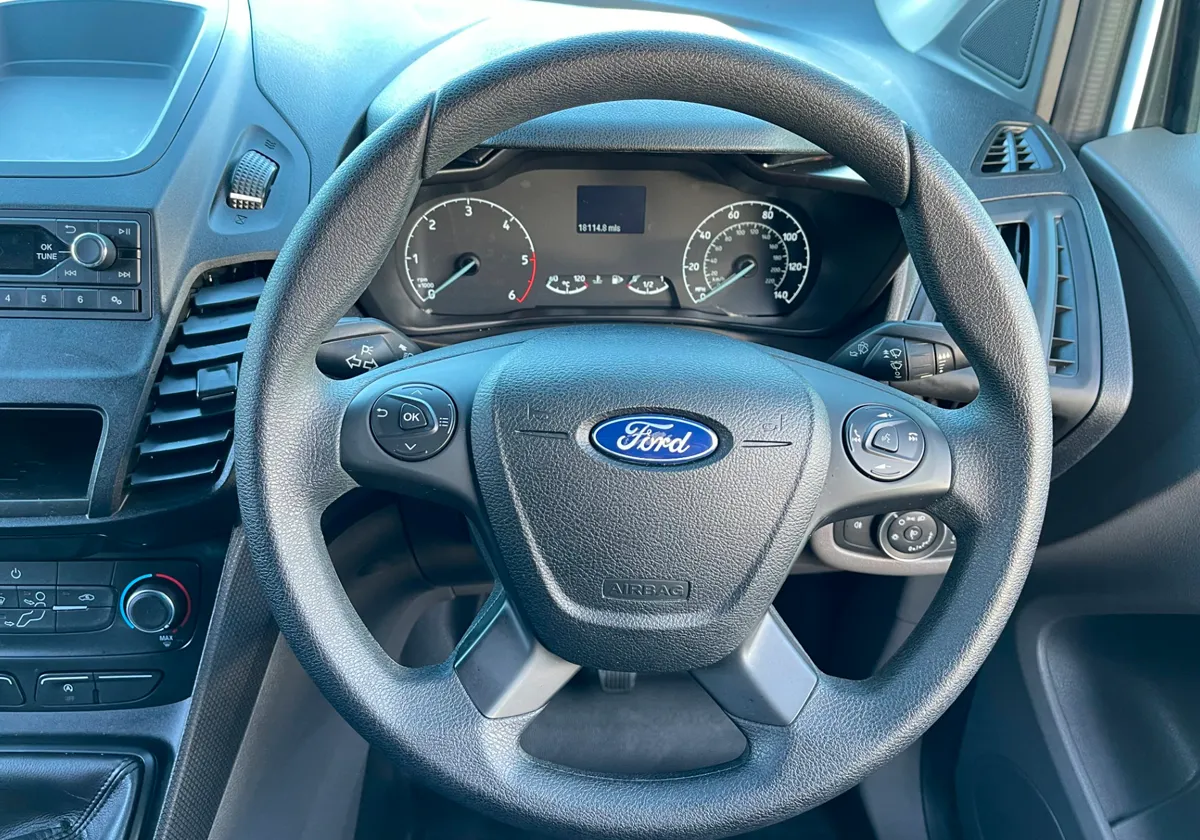 the dashboard and steering wheel of a Ford Transit Connect.