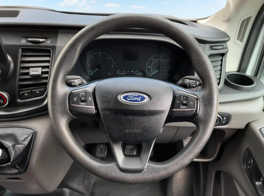 the steering wheel and dashboard of a Ford Transit Low Loader.