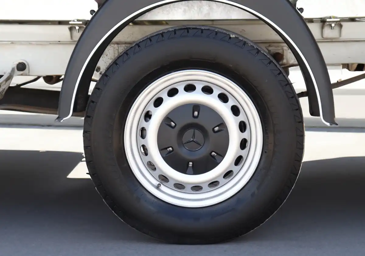 a close up of the wheel of a white Mercedes Sprinter Tipper.