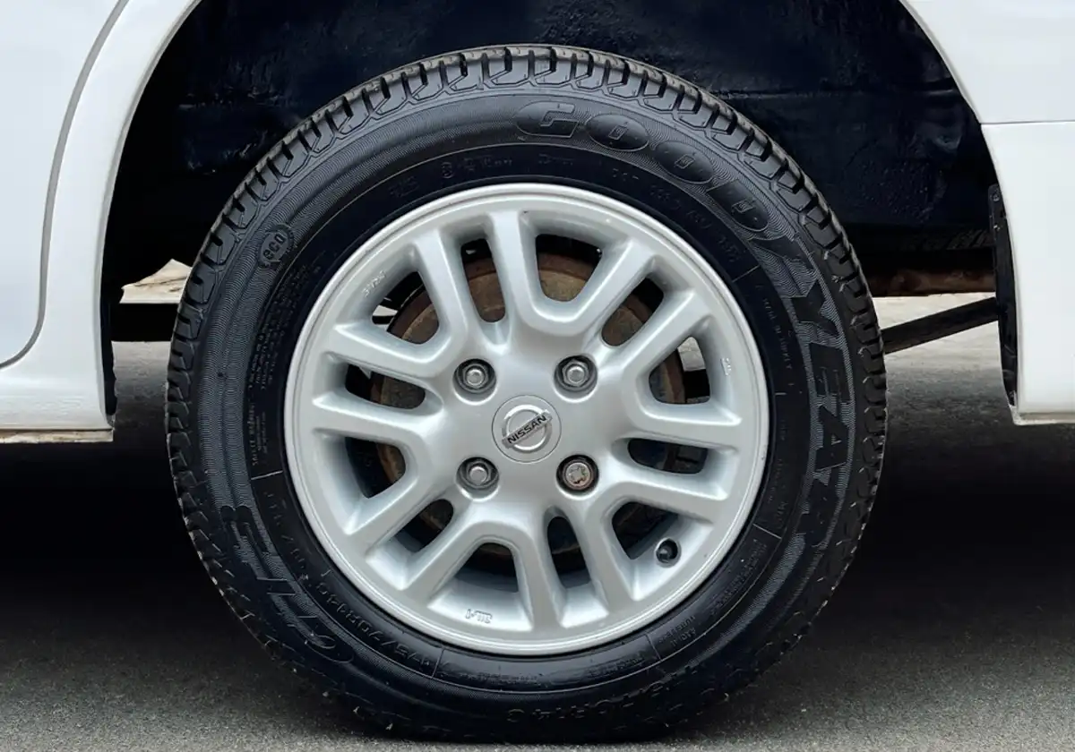 a close up of the wheel of a Nissan NV200.