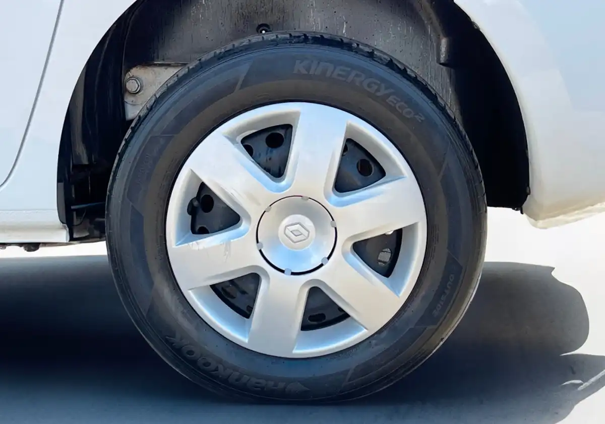 a close up of the wheel of a white Renault Kangoo.